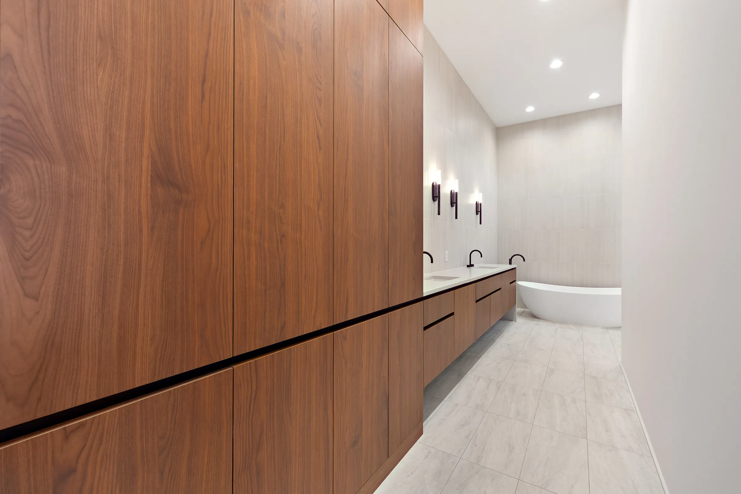 Walnut millwork and stone counters mid-craft — Seven Custom Homes