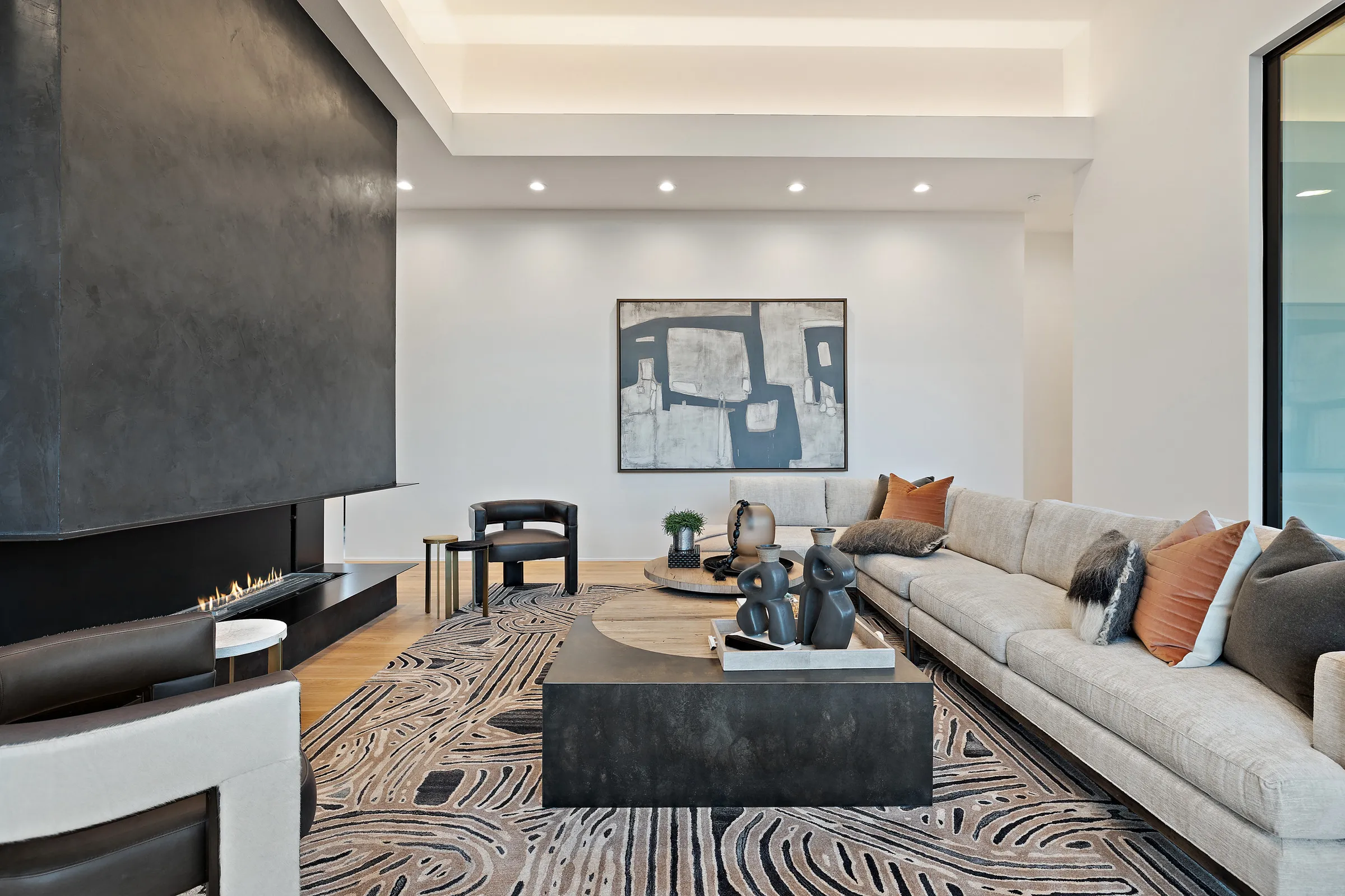 A finished great room with a linear fireplace and full-height glass — Seven Custom Homes